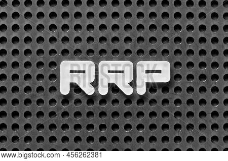 White Alphabet Letter In Word Rrp (abbreviation Of Recommended Retail Price) On Black Pegboard Backg