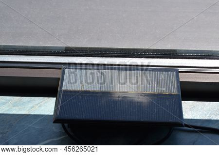 Solar Power Charger For Mobile Devices, Used At A Window