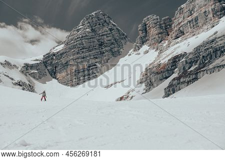 Cute Young Girl Learning To Skii At Winter Resort On A Sunny Day.