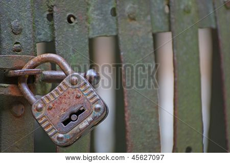 Old Rusty Padlock That Closes The Scratch Of An Ancient Prison Of Bandits