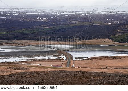 View Of Road Over River Amidst Volcanic Landscape At Eastfjords Against Mountain