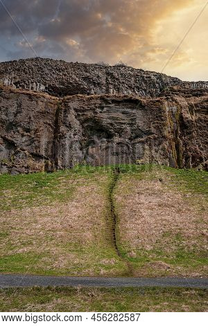 Scenic View Of Majestic Mountain By Road In Volcanic Valley Against Sky At Sunset