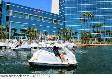 June 12, 2022 In Long Beach, Ca:  People Riding On Paddleboats Decorated As Swans On A Man Made Lake