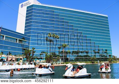 June 12, 2022 In Long Beach, Ca:  People Riding On Swan Style Paddleboats At A Lake Besides The Hyat
