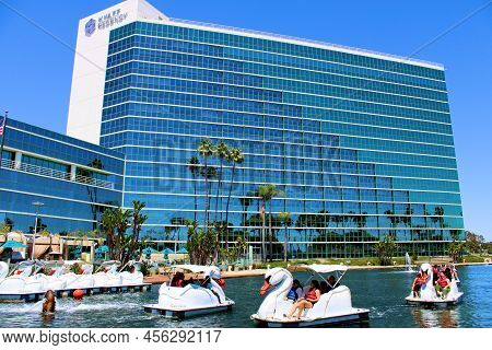 June 12, 2022 In Long Beach, Ca:  People Riding On Swan Style Paddleboats At A Lake Surrounding The 