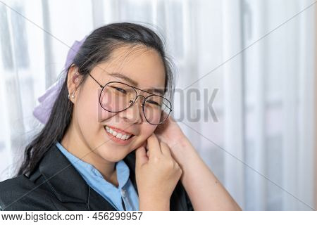 Close Up To Beautiful Asian Woman Face With Her Polite Glasses In Business Suit In Private Room.