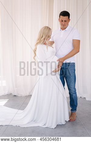 Happy Future Parents Of Man And Pregnant Woman Puts Hands On Belly And Waiting For Beby Movement In 