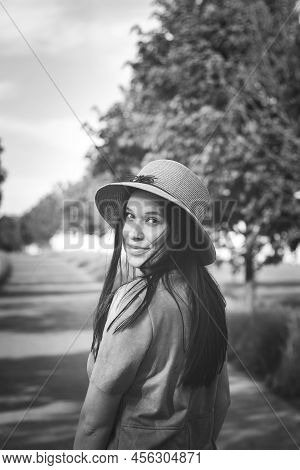 Black And White Candid Portrait Of A Brunette In A Stylish Cocoon With A Natural Smile. Breathtaking