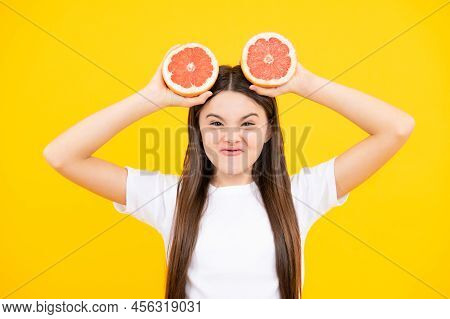 Funny Face. Happy Teenager Girl Hold Grapefruit Orangeisolated On Yellow Background, Kids Fruits Vit