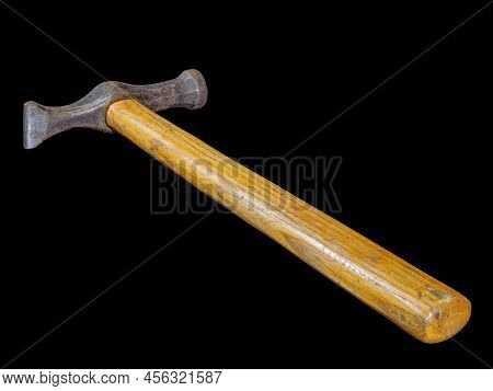 Used rusty hammer with wooden handle isolated on black background