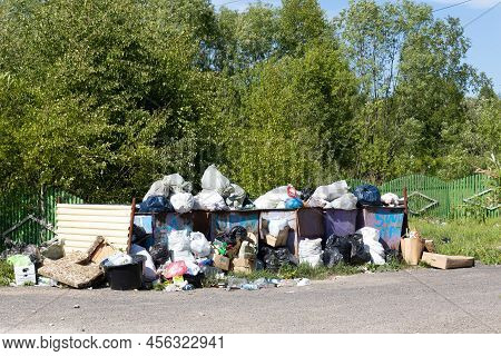 Krasnoyarsk, Russia - June 13, 2022: A Huge Pile Of Household Rubbish Near Dumpsters Full With Garba