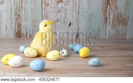 Easter Greeting Card With Plave For Text.small Chicken Surrounded With Colorful Eggs Against Blue Ba