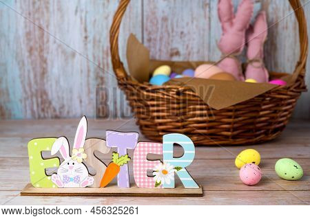 Easter Wooden Sign Stads Against Easter Basket With Eggs And Toy Bannies.happy Easter Banner