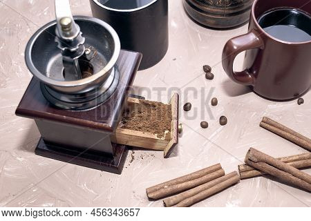 Coffee Grinder Two Mugs Of Cinnamon Coffee Beans And A Turk For Brewing Coffee On The Table