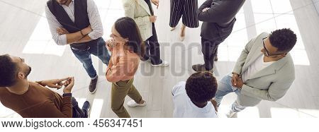 Group Of Young Multiracial Men And Women Meeting And Communicating At Business Event