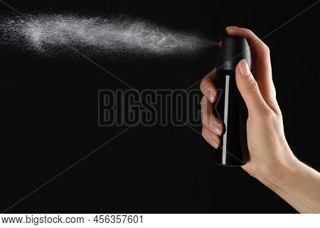 Woman Using Pepper Spray On Black Background, Closeup