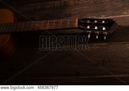 Classical Guitar Fretboard And Machine Head On A Dark Wood Background