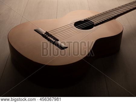 Classical Guitar On A Light Wood Background
