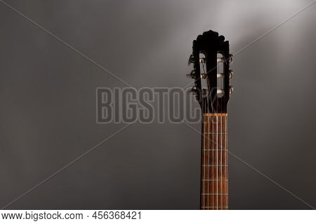 Classical Guitar Fretboard And Machine Head On A Grey Background With Copy Space