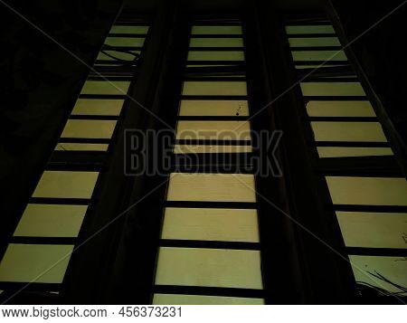 Stock Photo Of Rectangle Shape Window With Grill In Living Room With Floral Curtains. Picture Captur