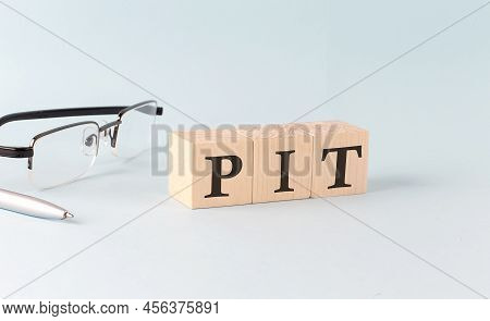 Text Pit - Written On The Wooden Cubes On A Blue Background