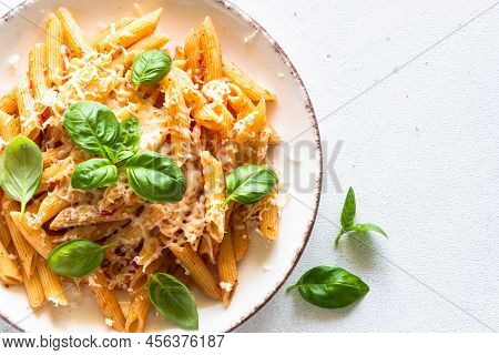 Pasta With Tomato Sauce, Basil And Parmesan On White Table. Penne Pasta With Tomato Sauce Alla Arrab