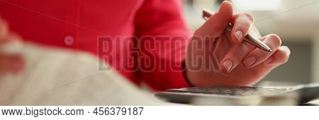 Close-up Of Woman Calculating Total Amount Of Expense At End Of Month. Woman Use Calculator, Checks 