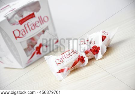 Raffaello Sweets On A Light Wooden Table And White Background.