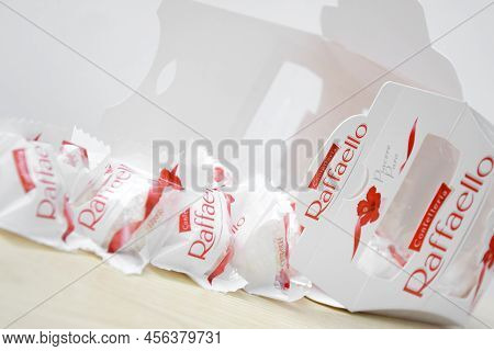 Raffaello Sweets On A Light Wooden Table And White Background.