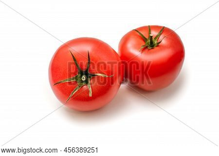 Two Juicy Tomatoes On A White Isolated Background. Fresh Juicy Tomatoes With Green Stems. Vegetables