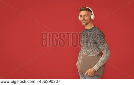 Happy Man In Casual Listen To Online Audio Course In Headphones Holding Laptop, E-education