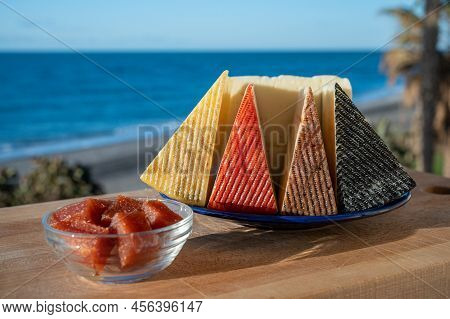 Assortment Of Spanish Hard Cheeses, Curado, Manchego, Goat Cheese Served Outdoor With Membrillo Jam