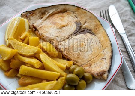 Seafood Dish, Grilled Steak From Swordfish Or Spada Served With French Fried Potatoes And Green Oliv