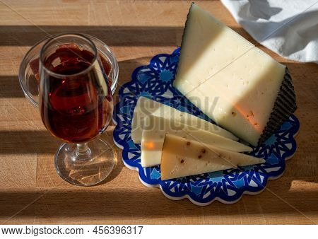 Spanish Hard Manchego, Cow, Sheep And Goat Cheeses Served Outdoor With Membrillo Jam And Glass Of Sh