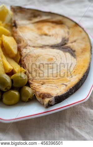 Seafood Dish, Grilled Steak From Swordfish Or Spada Served With French Fried Potatoes And Green Oliv