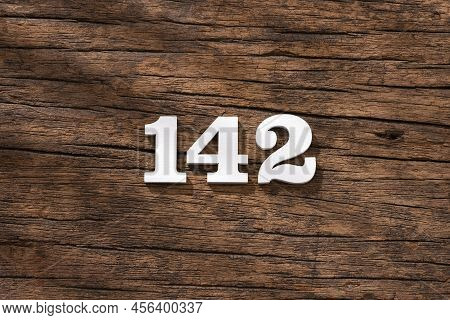 Number 142 In Wood, Isolated On Rustic Background