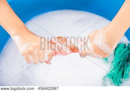 Closeup Young Asian Woman Use Hands Washing Color Clothes In Basin. Female Squeeze Wring Out Wet Fab