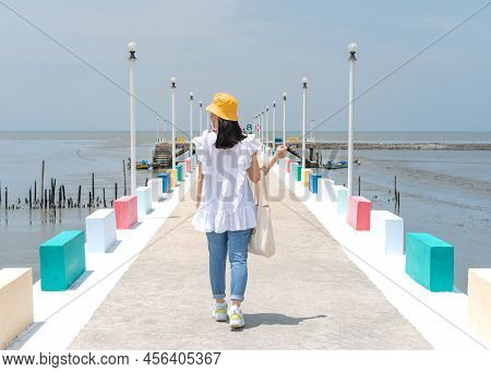 The Back View Of Asian Woman Walking On The Rainbow Bridge To See The Viewpoint At The Samut Sakorn 