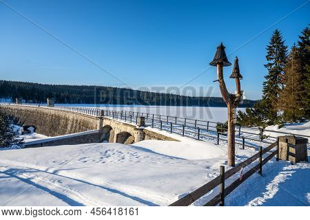 Cerna Nisa, Or Bedrichov, Dam In Sunny Winter Evening. Snowy Landscape Wing Long Sunset Time Shadows