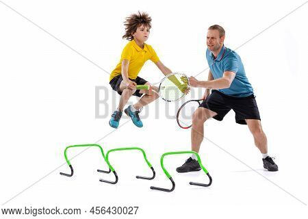 Tennis Lesson. Professional Tennis Player, Instructor Shows Basic Techniques In Game Of Tennis To Sc