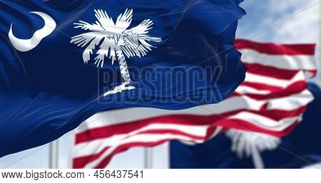 The South Carolina State Flag Waving Along With The National Flag Of The United States Of America. S