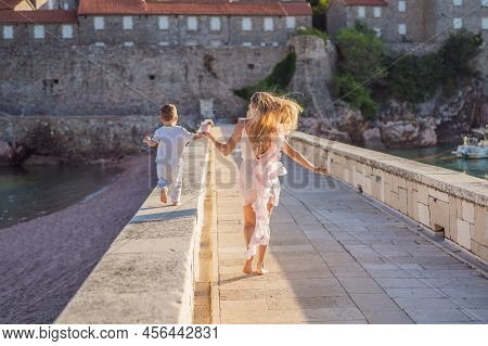 Mother And Son Tourists On Background Of Beautiful View St. Stephen Island, Sveti Stefan On The Budv
