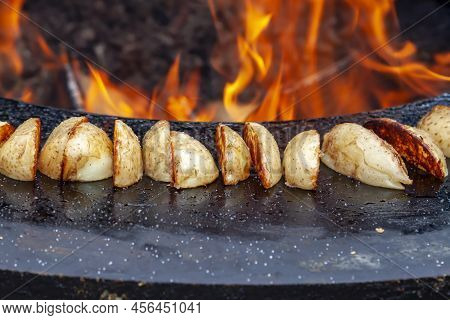 Close Up Vegan Cuisine. Big Slice Potatoes Hot Bbq Charcoal Grill. Flames Fire Grill Background. Out