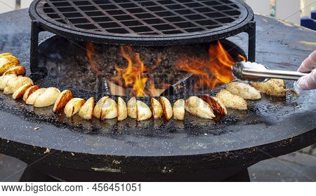 Vegan Cuisine: Big Slice Potatoes Hot Bbq Charcoal Grill. Flames Fire Grill Background. Outdoor Summ