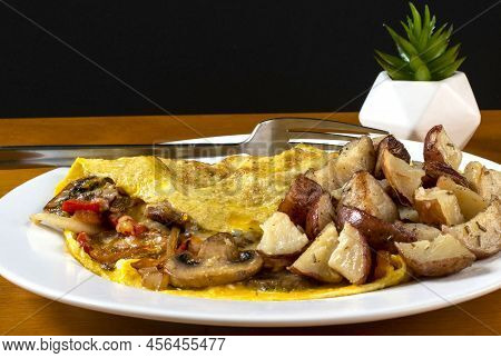 Mushroon Peppers And Onion Omelet Served With Home Fries