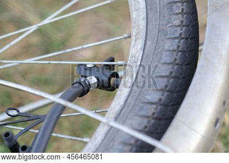 Close-up Of Bicycle Tire Inflating Valve.pump Valve Connected To The Wheel.
