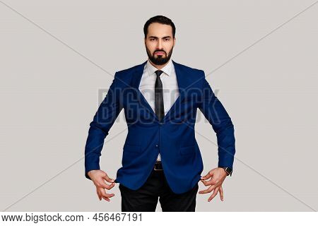 Portrait Of Sad Unhappy Bearded Man Showing Empty Pockets Inside Out, Going Bankrupt, No Cash For Li