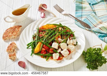 Fasolakia Lathera, Green Beans, Onion And Potatoes Stewed In Tomato, Herbs And Olive Oil On White Pl