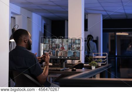 African American Man Talking To Coworkers On Remote Videoconference Call, Using Online Teleconferenc