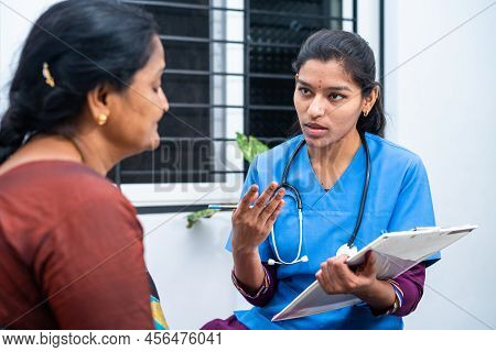 Nursing Examining Sick Woman Patient By Noting Record Or Checking Health Conditions At Clinc - Conce